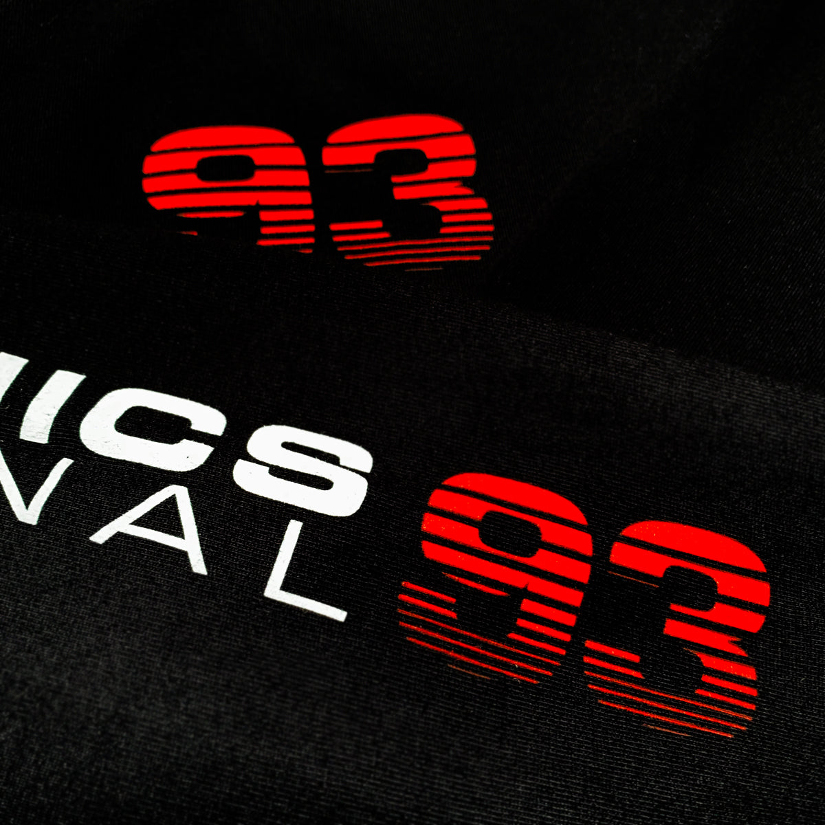 Close up hieroglyphics 93 wordmark on the chest of long sleeve white t-shirt. 