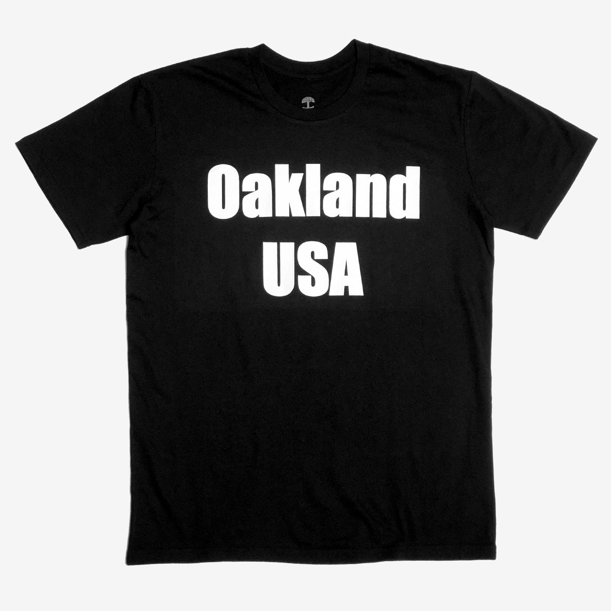 A black t-shirt with a large white Oakland USA wordmark logo on the chest.