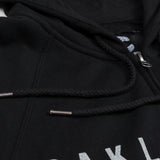 Close up of the zipper pull and hood strings on a black Oaklandish hoodie.