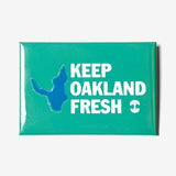 Green magnet with blue lake and KEEP OAKLAND FRESH wordmark and white Oaklandish tree logo.