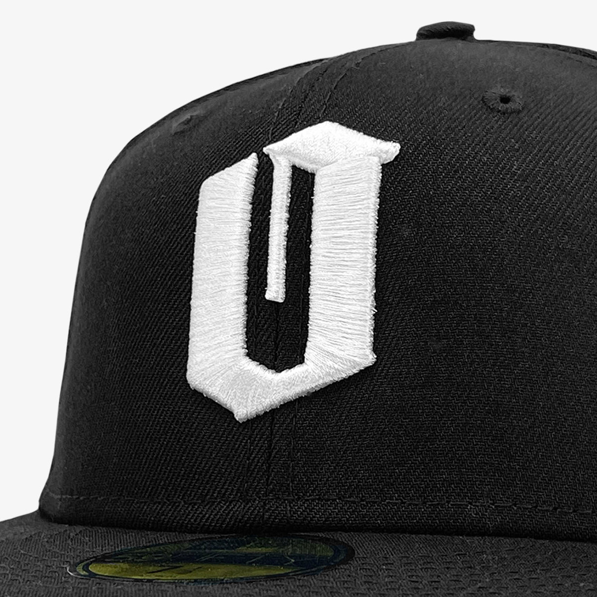 Close up of white embroidered O for Oakland on black New Era cap.