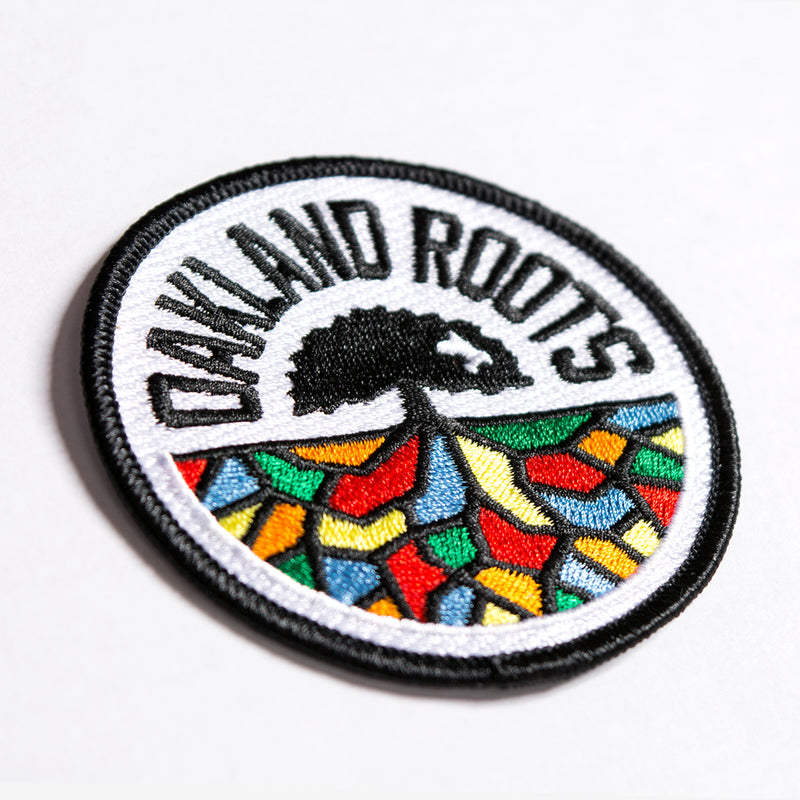 Angled view of embroidered round patch of Oakland Roots full-color logo crest.