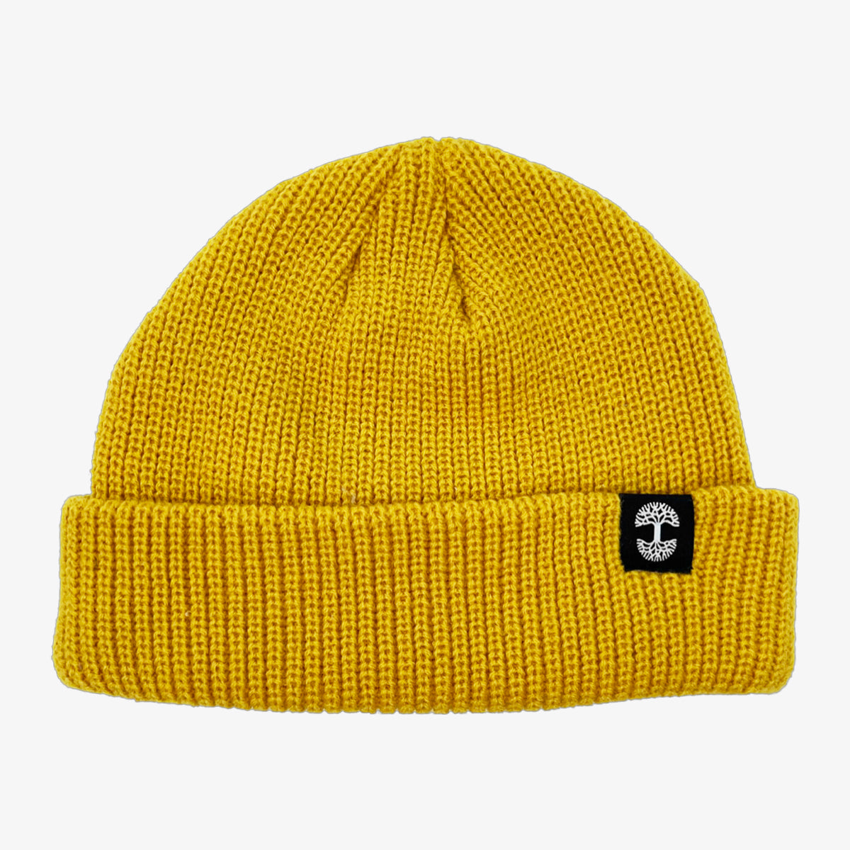 Shallow fit mustard yellow cuffed beanie with black and white Oaklandish tree logo tag on the left wear side. 