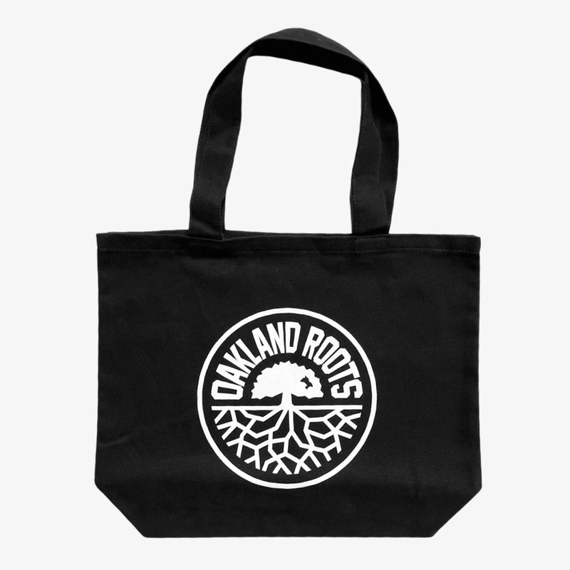 Black reusable shopping tote with large white Oakland Roots logo crest.