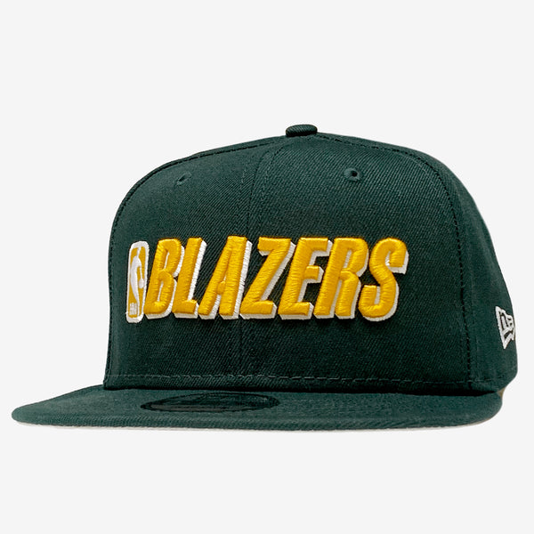 Green cap with embroidered gold BLAZERS and NBA  logo on the crown. 