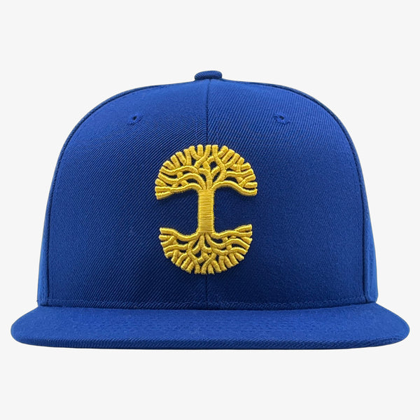 Royal blue cap with gold embroidered Oaklandish tree logo on the front.