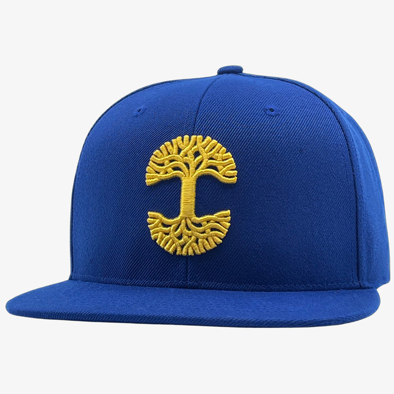 Royal blue cap with gold embroidered Oaklandish tree logo on the front.