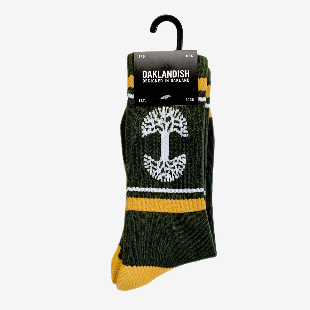 Green socks with white Oaklandish tree logo between yellow and white ankle stripes in Oaklandish retail packaging.