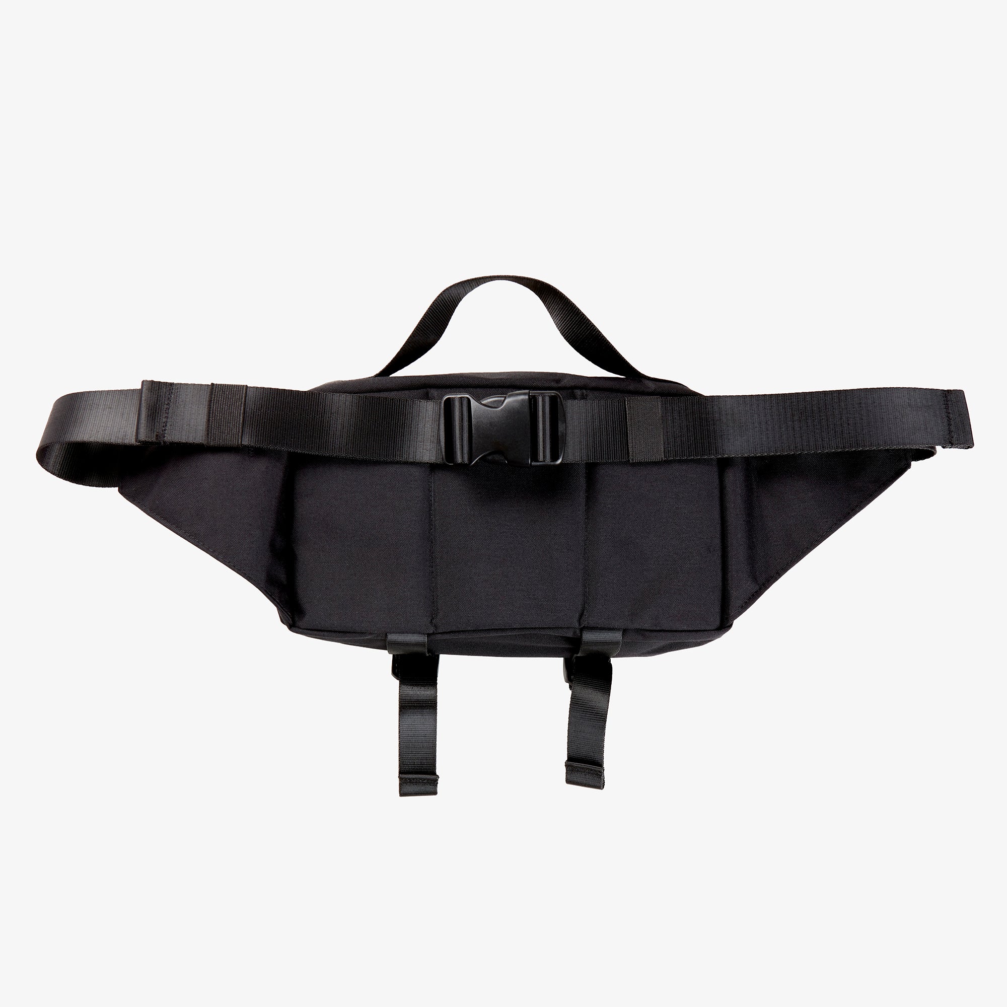 The backside of black nylon hip bag with black waist belt and top handle.