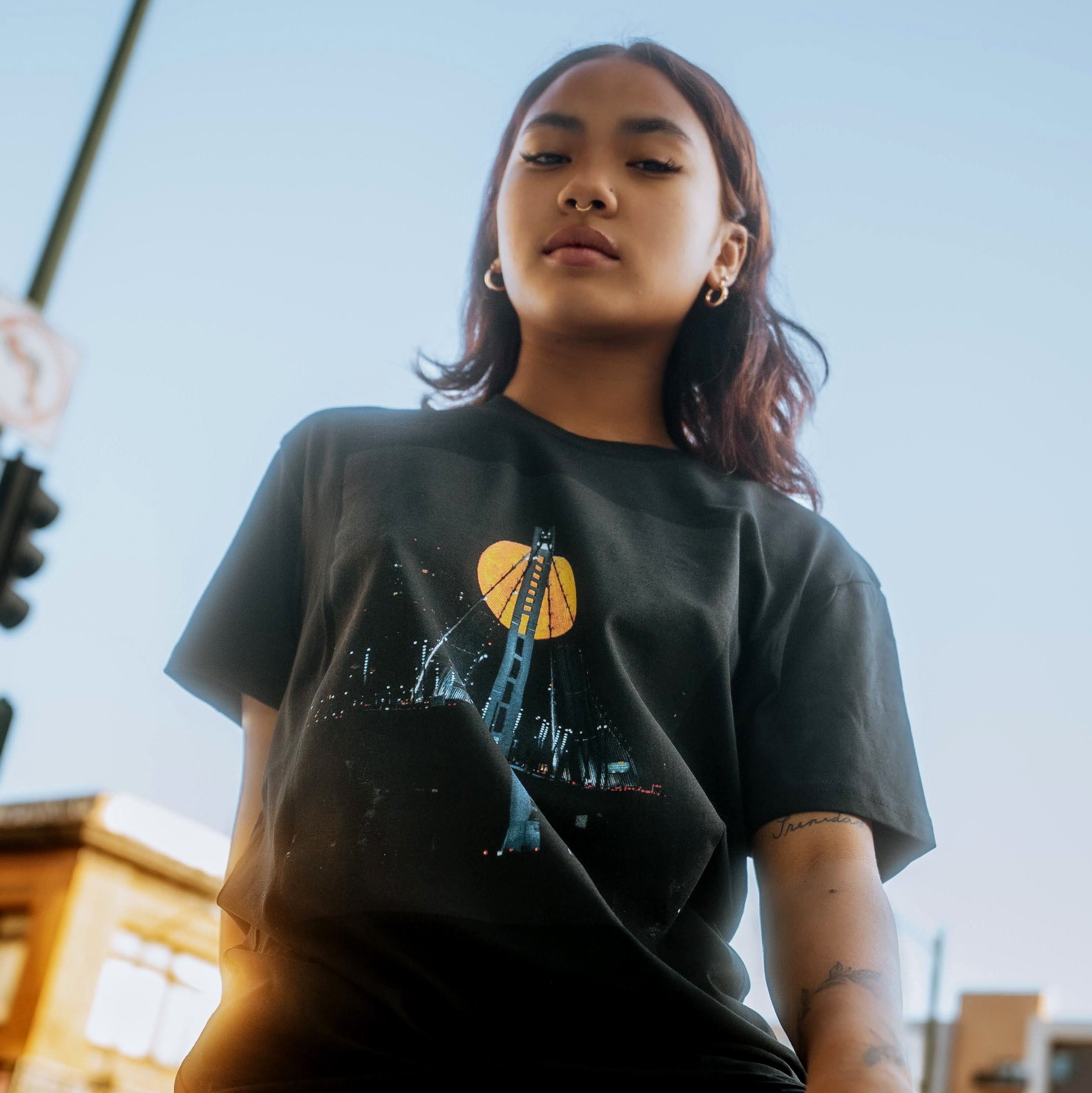 Closer detail image of female model wearing black t-shirt with Voncent James' Strawberry Moon image.