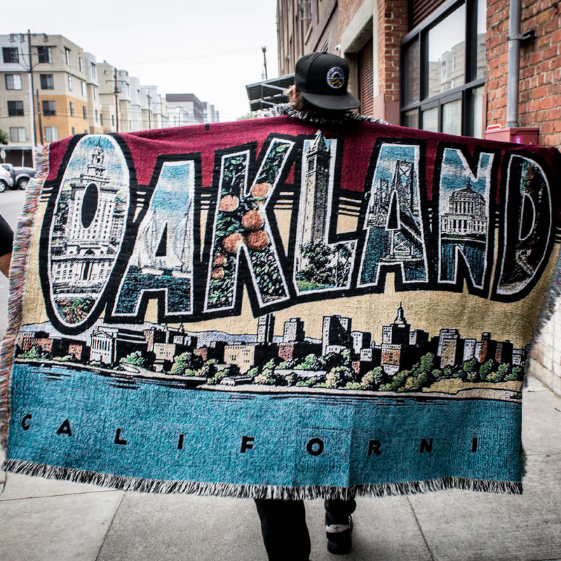 Photo of Male outside with arms stretched  and throw Blanket - Greetings From Oakland, Cotton, Made in USA
