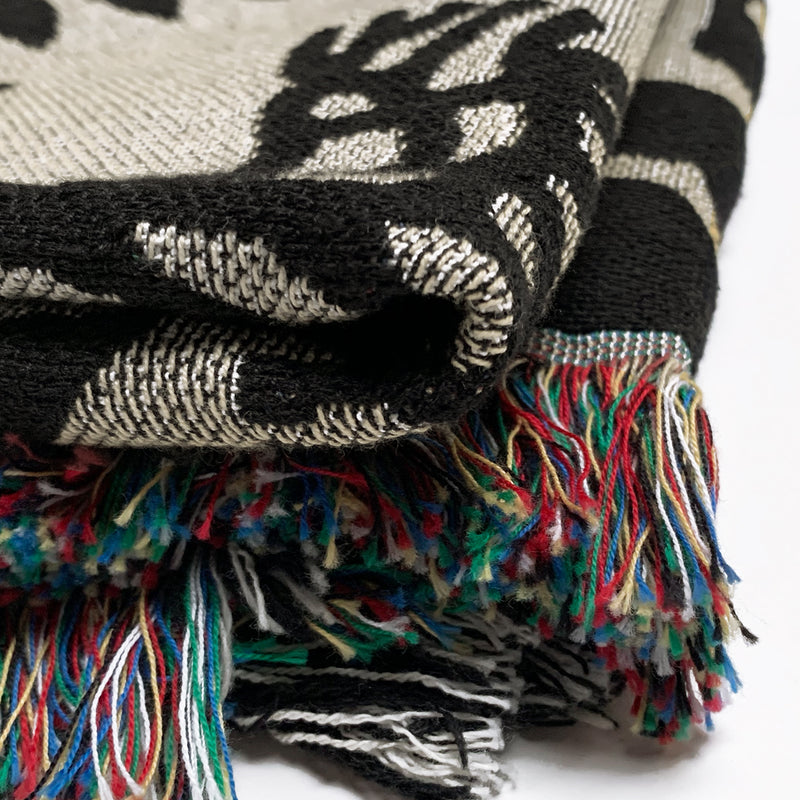 Detailed close up of folded throw blanket - viva oakland - black and gold -100% cotton