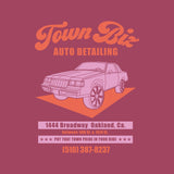 Close-up of Town Biz Auto Detailed ad with car and “Put that Town Pride in Your Ride” tagline on berry red t-shirt.
