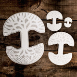 Four sizes of the Oaklandish tree logo car window decals (small, medium, large and extra large) on a wooden picnic table.