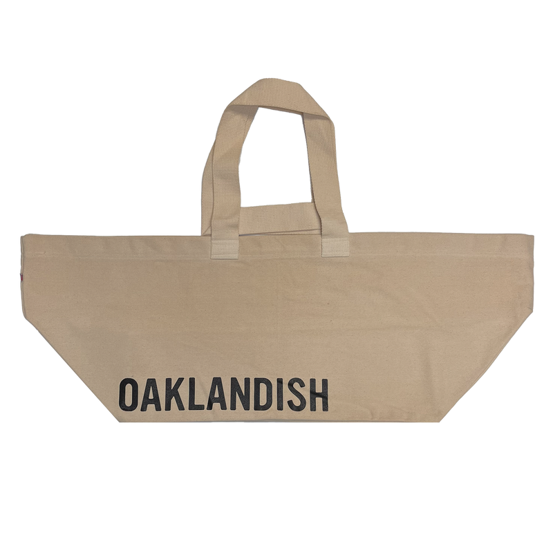 Extra wide natural colored bull denim shopping tote bag with black Oaklandish wordmark.