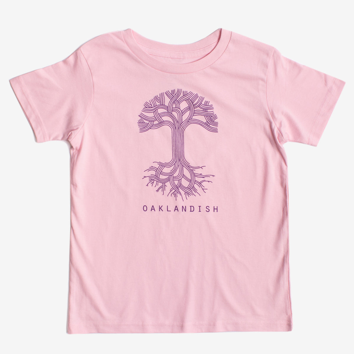 The Youth Oaklandish Classic Logo Tee by Oaklandish features a pink base adorned with a stylized purple tree graphic on the chest. The tree showcases intricate, branching roots and limbs that mimic circuit board patterns. Below the tree, "OAKLANDISH" is printed in bold purple capital letters. Crafted from 100% cotton, it ensures ultimate comfort.