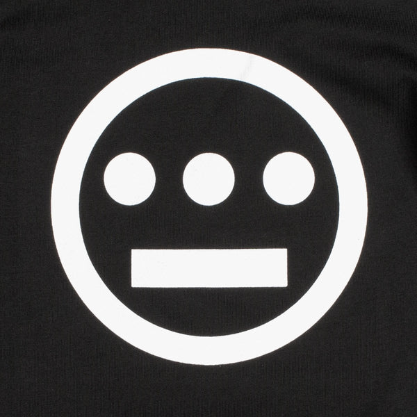 Close-up of white Hiero hip-hop crew logo on the chest of a black youth sized t-shirt.